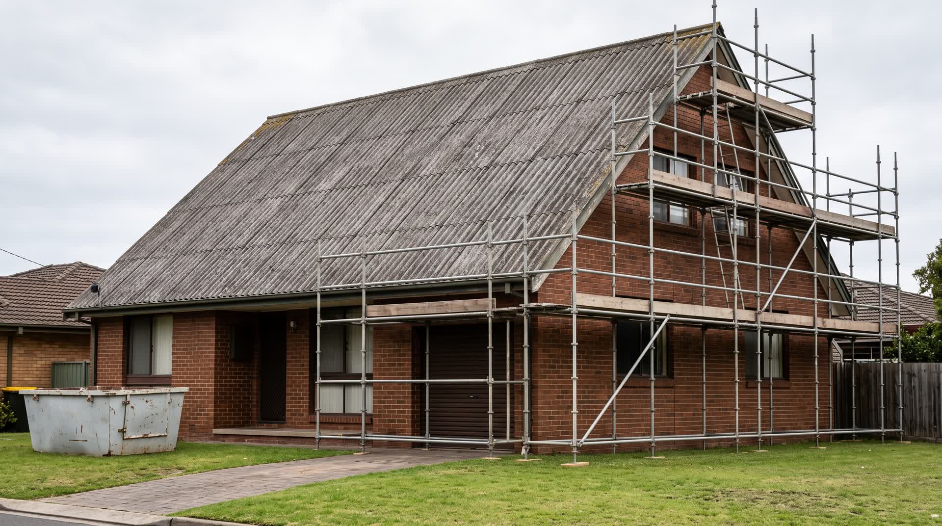 Asbestos roof removal cost: scaffold erected against a steep corrugated fibro roof on a two-storey Sydney house